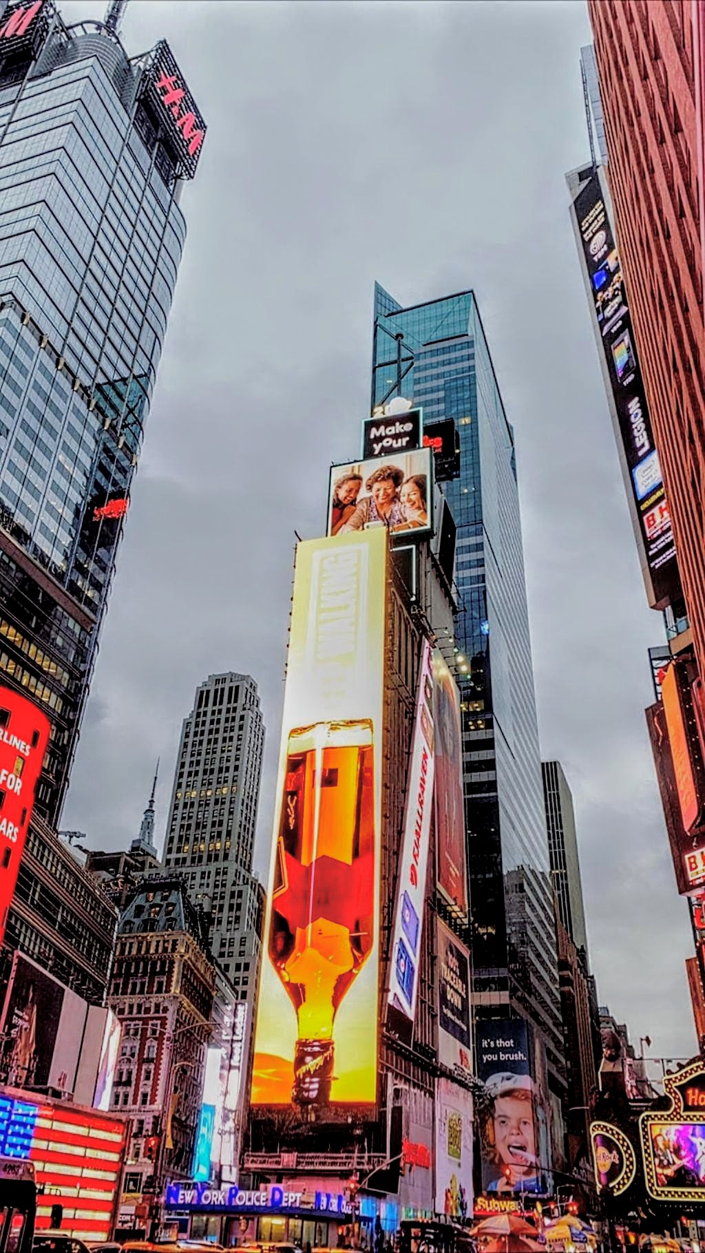 Hands typing on silver laptop keyboard in cafe setting